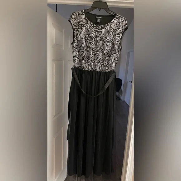 silver top black bottom dress Dressed in black, powered by confidence. REUSE BLACK AND SILVER LONG  SLEEVELESS GOWN WITH CRYSTALS AND CAPE